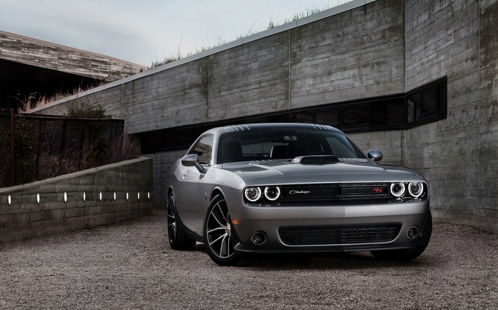 Silver Dodge Challenger RT parked near concrete building