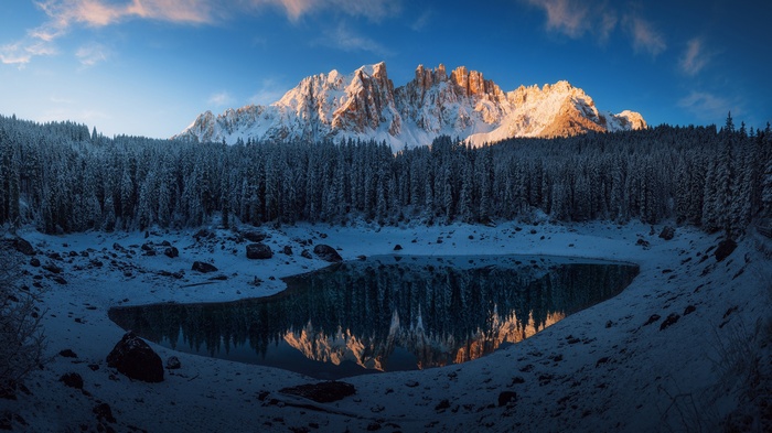 Snowy Dolomites mountains reflected in a lake