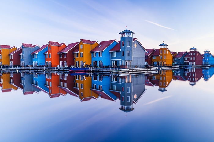 Colorful houses reflected in still water