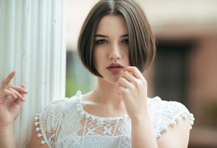 Portrait of a woman with short hair and pink lipstick