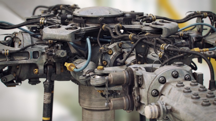 Close-up of a complex helicopter rotor head mechanism