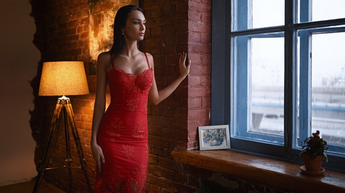 Woman in red dress by the window