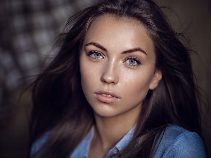 Portrait of a young woman with blue eyes and dark hair