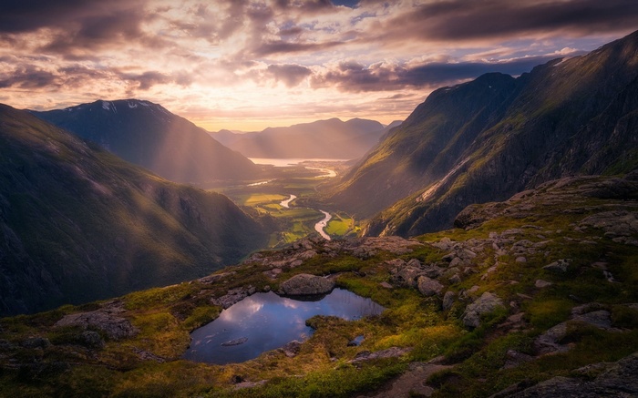 Valley with river and mountains at sunset in Norway