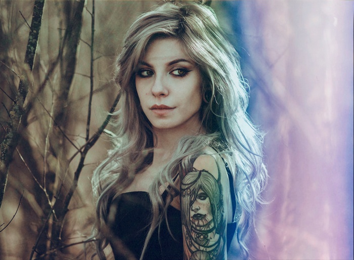 Woman with tattoo in forest