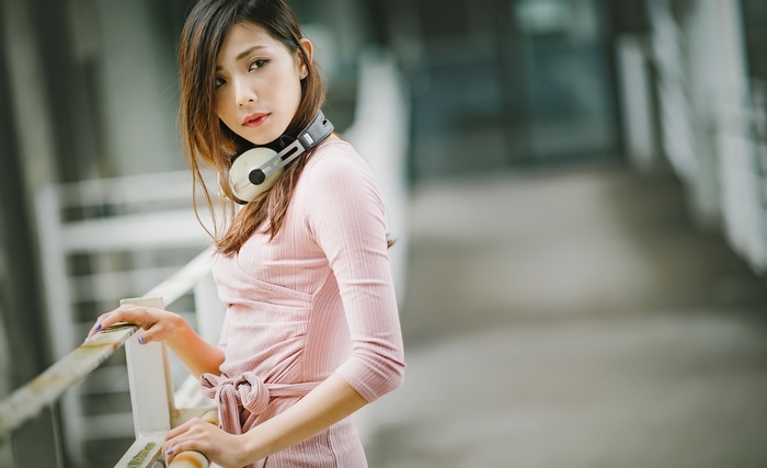 Asian woman with Sennheiser headphones