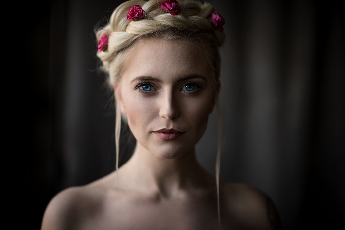Woman with blonde braided hair and blue eyes