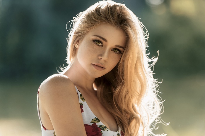 Portrait of Yvonne Michel with blonde hair and green eyes