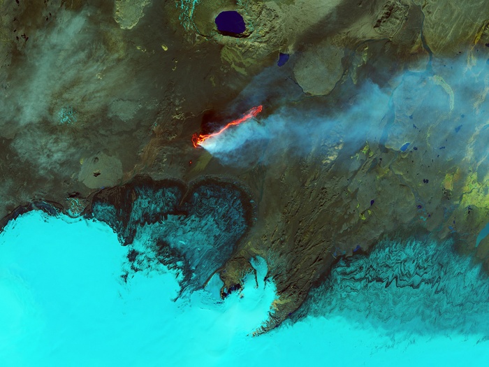 Aerial view of volcanic eruption in Iceland with lava and smoke