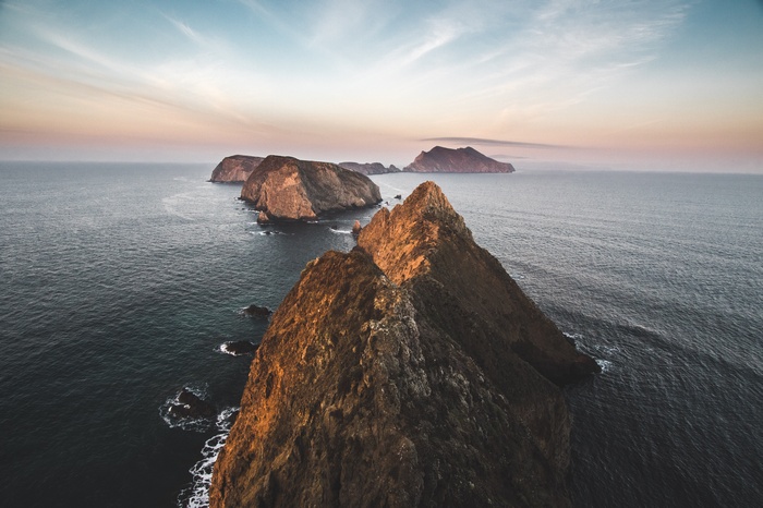 Rocky islands in the ocean at sunset