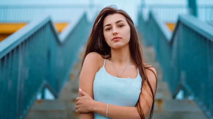 Woman in a light blue dress on stairs