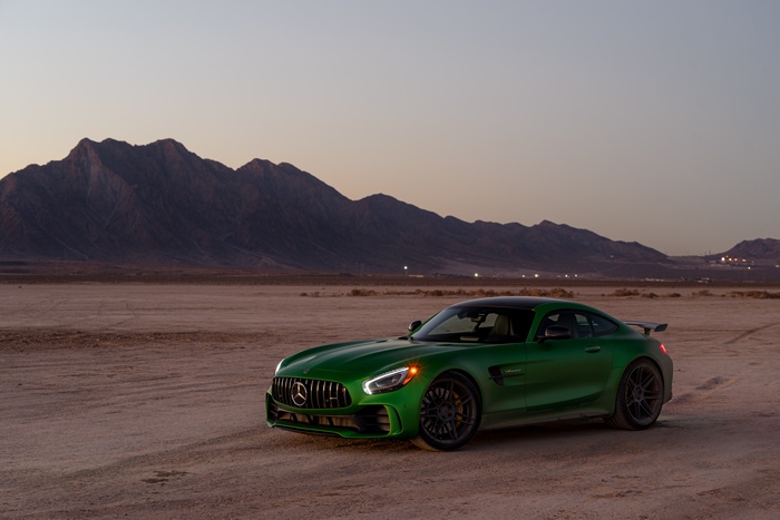 Green Mercedes-AMG GT R in a desert landscape at dusk