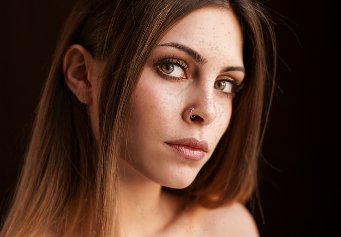 Woman with freckles and nose ring
