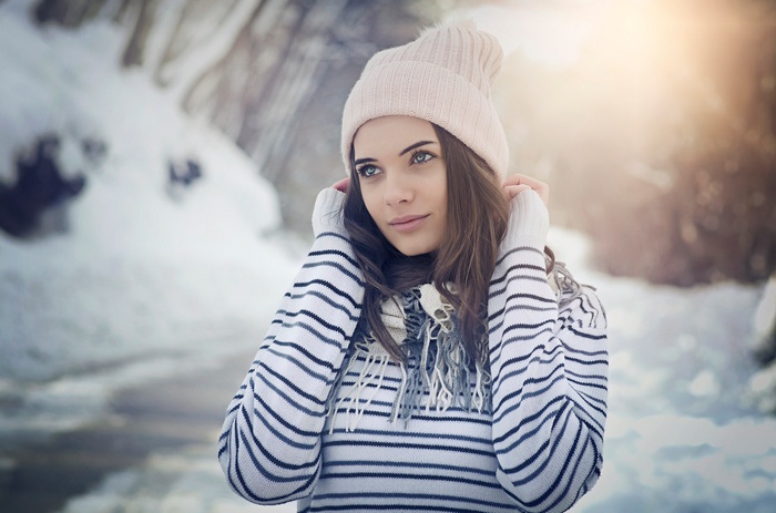 Woman in winter hat and sweater outdoors