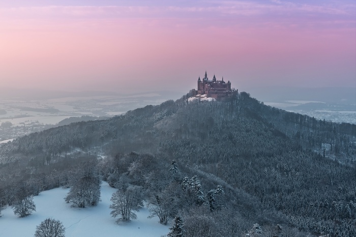 Hohenzollern Castle in winter landscape at sunset