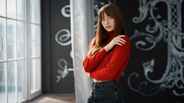 Woman in red turtleneck and jeans