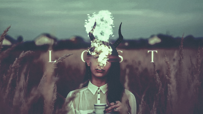 Woman with horns and fire in a field