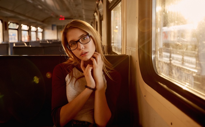 Young woman with glasses on a train