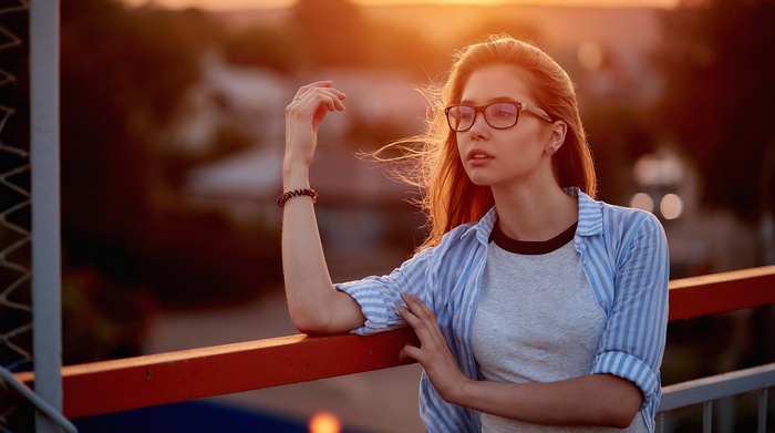 Woman with glasses at sunset