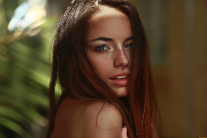 Woman with freckles and green eyes outdoors