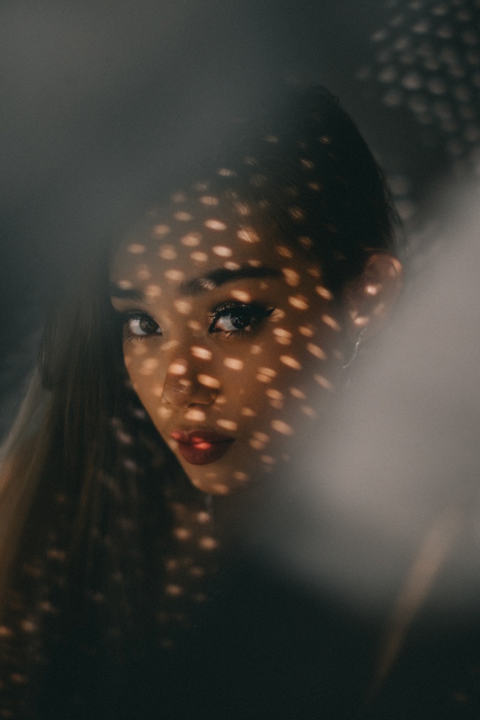 Woman with dappled light on her face