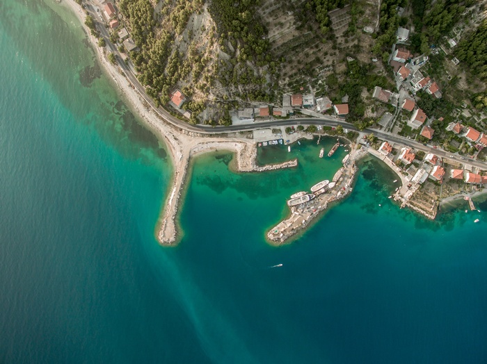 Aerial view of a coastal town with a harbor and boats