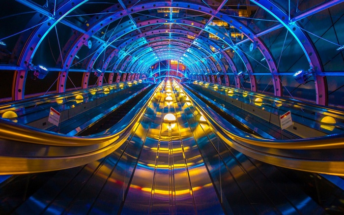 Escalator tunnel with blue and yellow lights