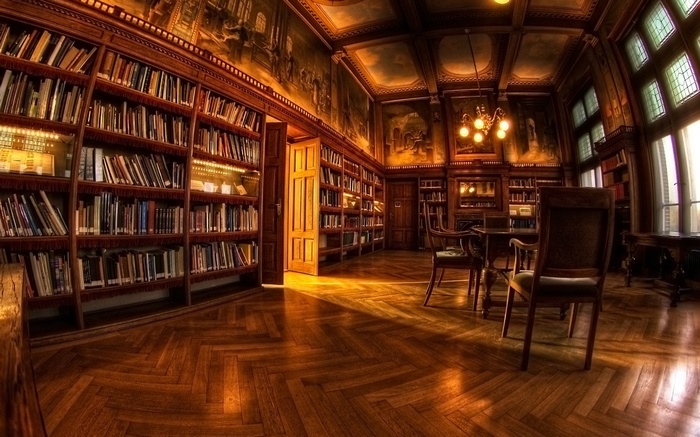 Interior of a grand library with bookshelves and seating