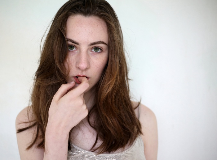 Woman with long brown hair and green eyes