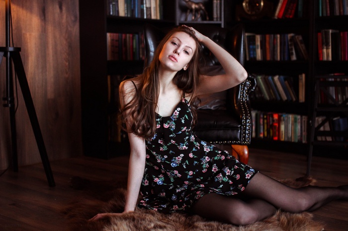 Woman with long hair sitting on the floor