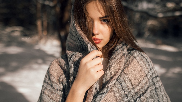 Woman in a scarf in the snow
