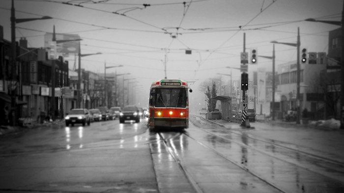 Red streetcar on a wet street in Toronto