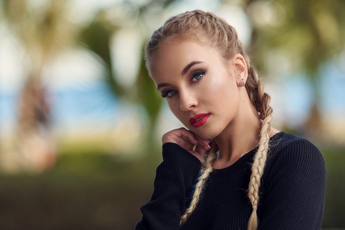 Woman with blonde pigtails and blue eyes