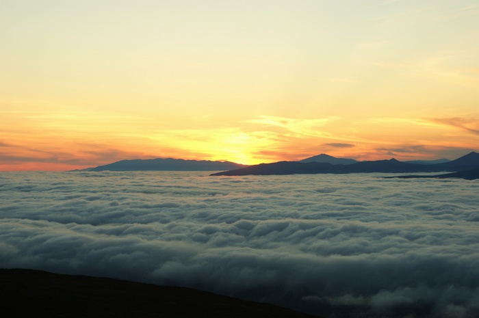 Sunset over clouds and mountains in Magadan, Russia