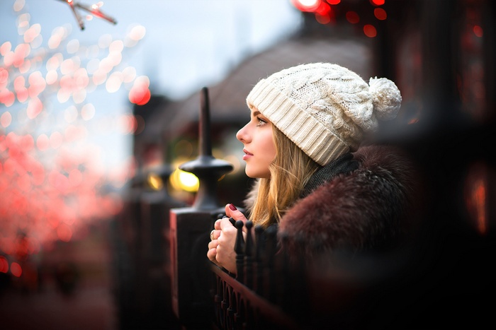 Woman in winter hat and fur coat looking into the distance