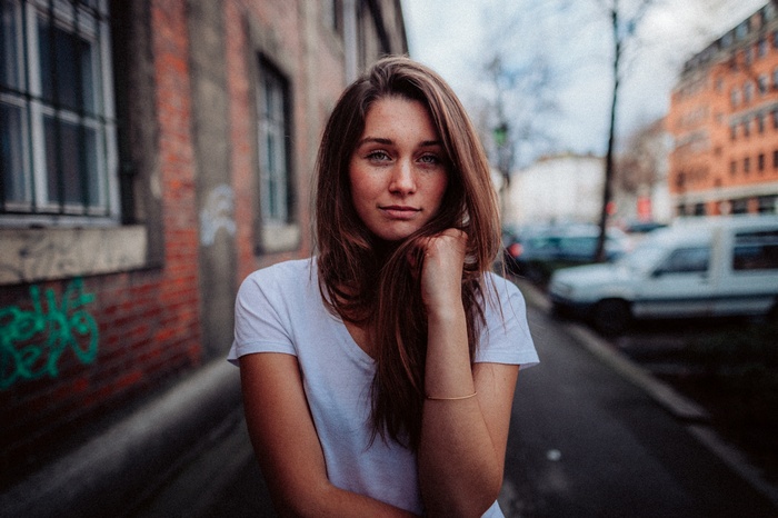 Woman with freckles wearing a white t-shirt outdoors