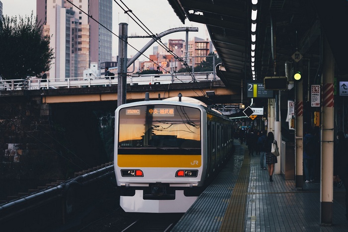 Train at a Japanese train station with cityscape reflection