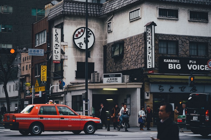 Red taxi in front of Ningyocho Station, Japan