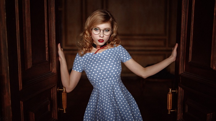 Woman in polka dot dress and glasses