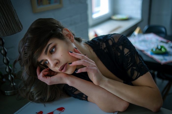 Woman with dark hair and black lace top