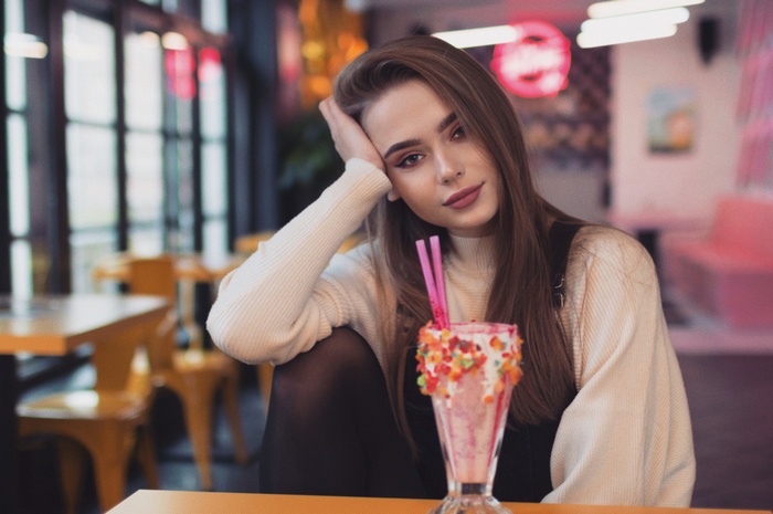 Woman with milkshake in a restaurant