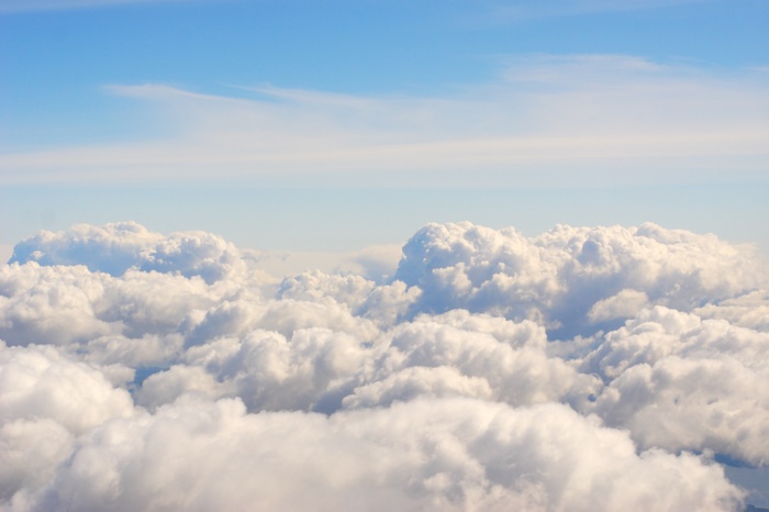 Fluffy white clouds against a bright blue sky