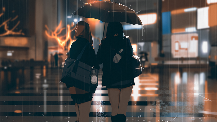 Two girls with umbrella walking in the rain