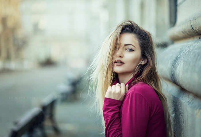 Woman with blonde hair and blue eyes outdoors