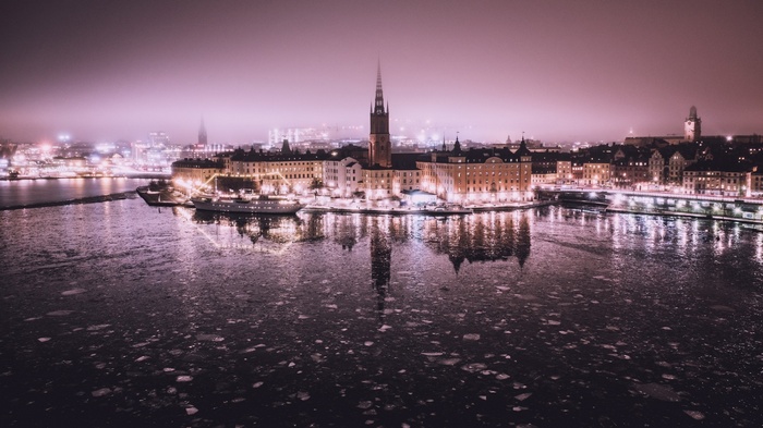 Stockholm cityscape at night with ice on the water