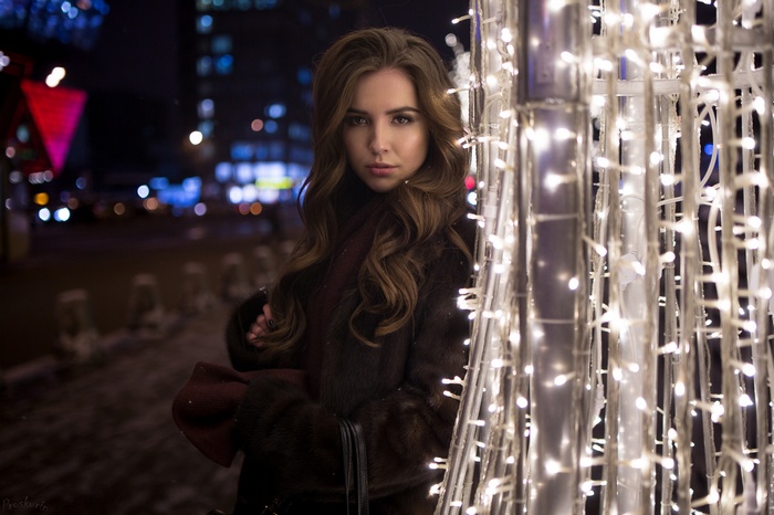 Woman in fur coat with Christmas lights