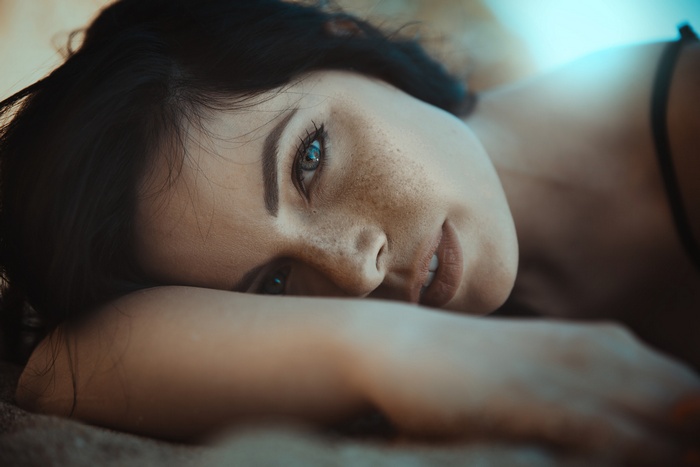 Woman with freckles lying down