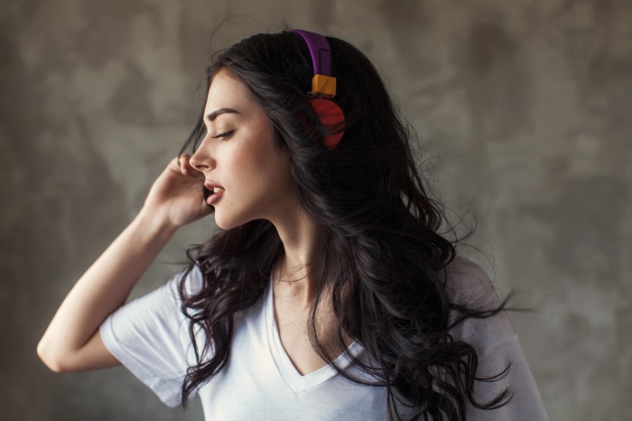 Woman wearing headphones and white t-shirt