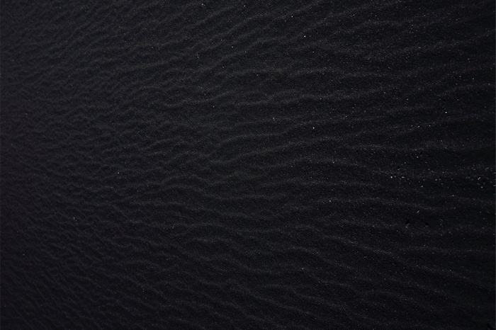 Black sand texture with ripples