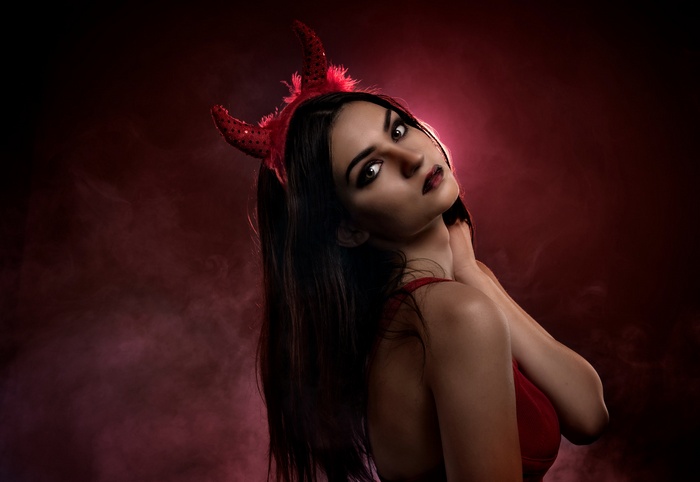 Woman with devil horns and red lipstick